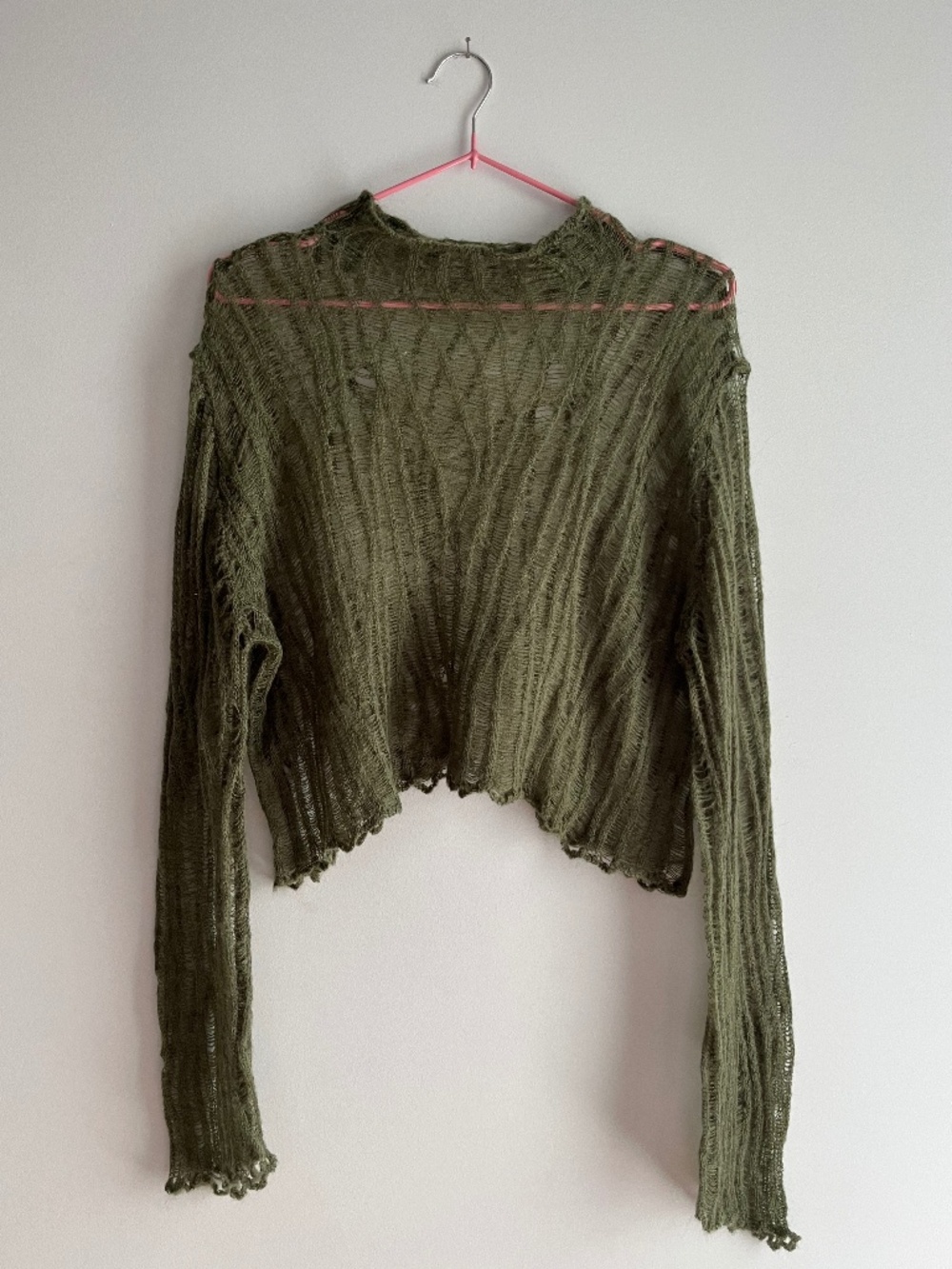 Grunge open knit crop sweater with ruffled hem in green